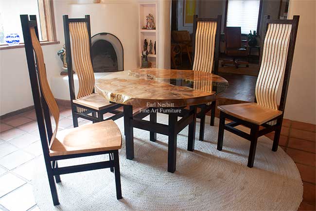 round live edge dining table at another angle showing more of table base and curly maple bent laminate slats on chairs